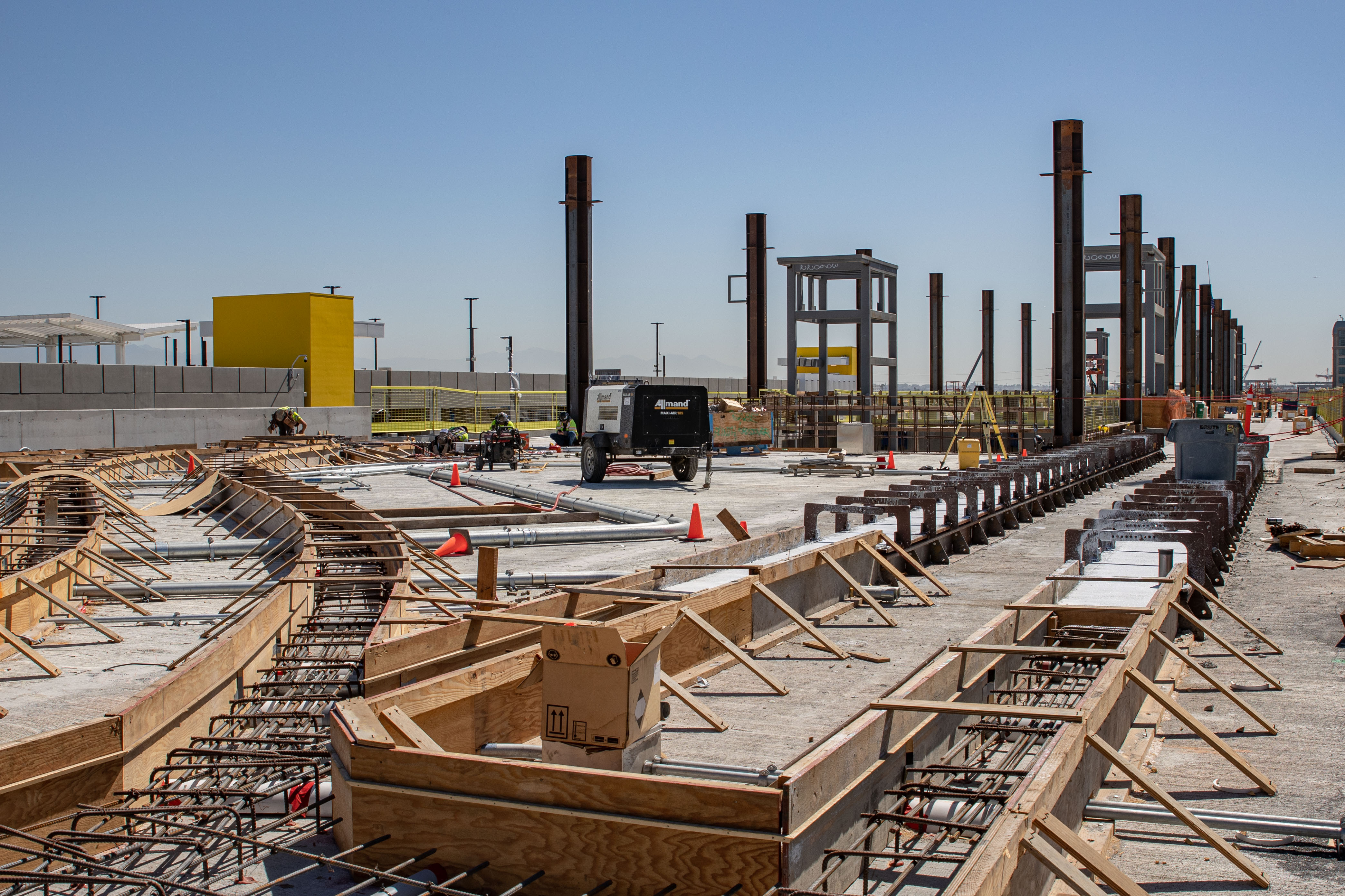 The Automated People Mover track plinths are under construction on the guideway adjacent to the Intermodal Transportation Facility-West station.